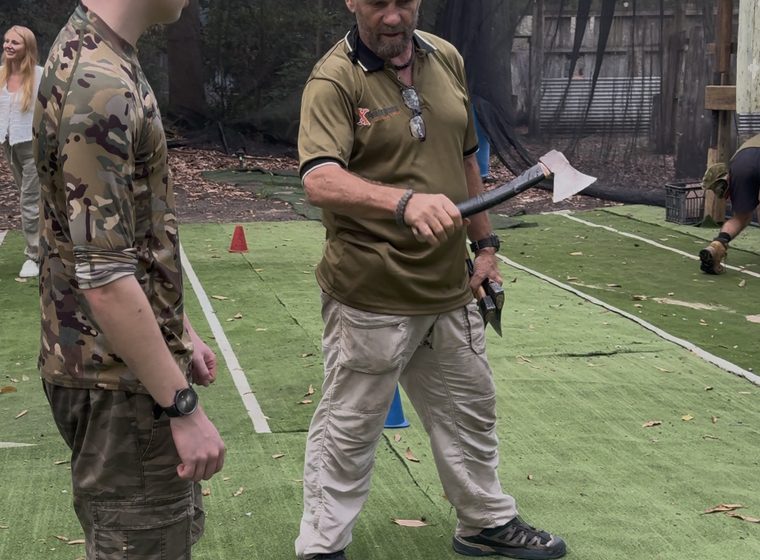 A coach running through grip and stance before the first throw