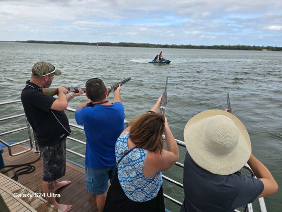 Participants tracking clays out over the water